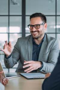 Business man explaining insurance to people