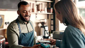 Cafe worker accepts an electronic payment