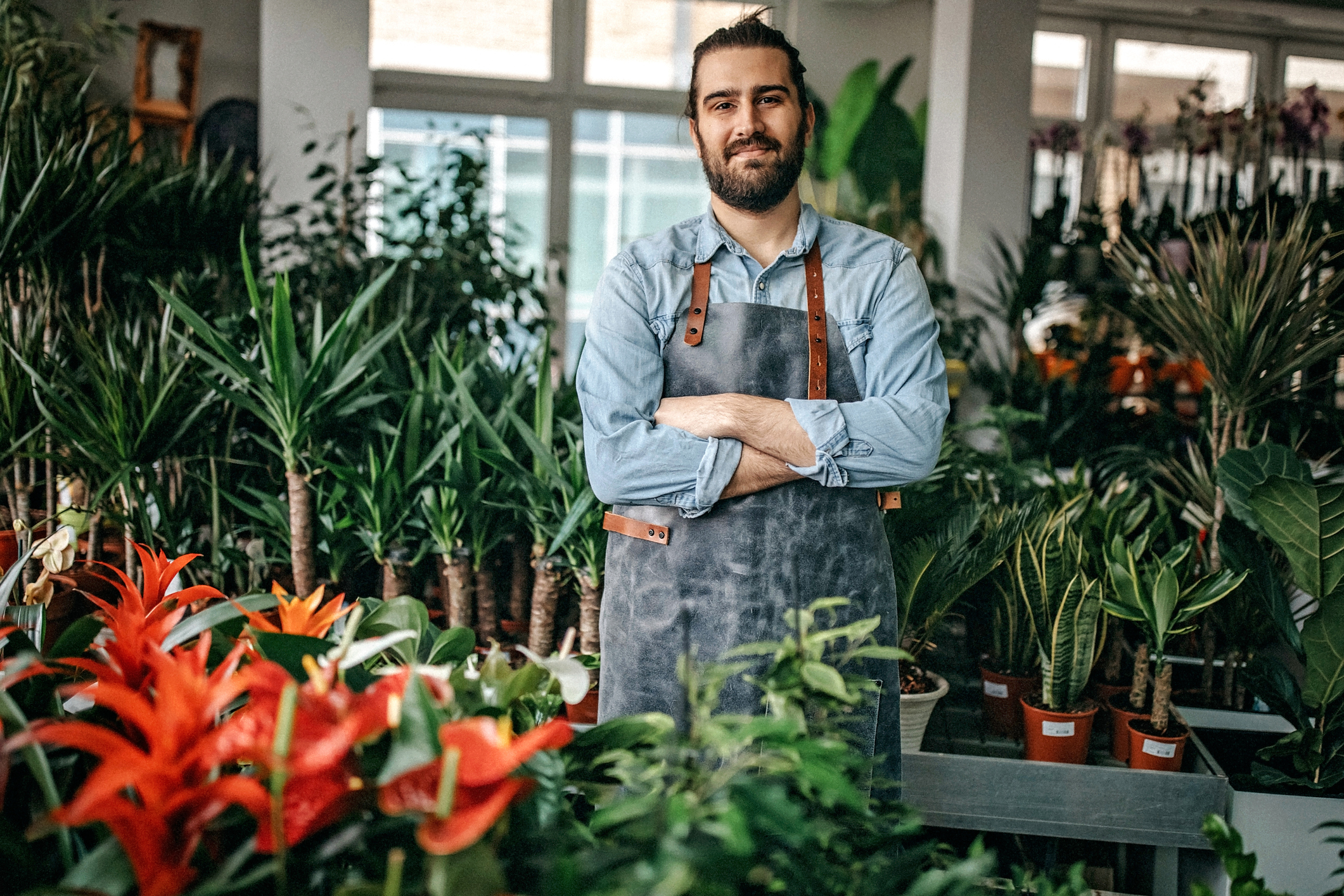 Man standing with plants around him