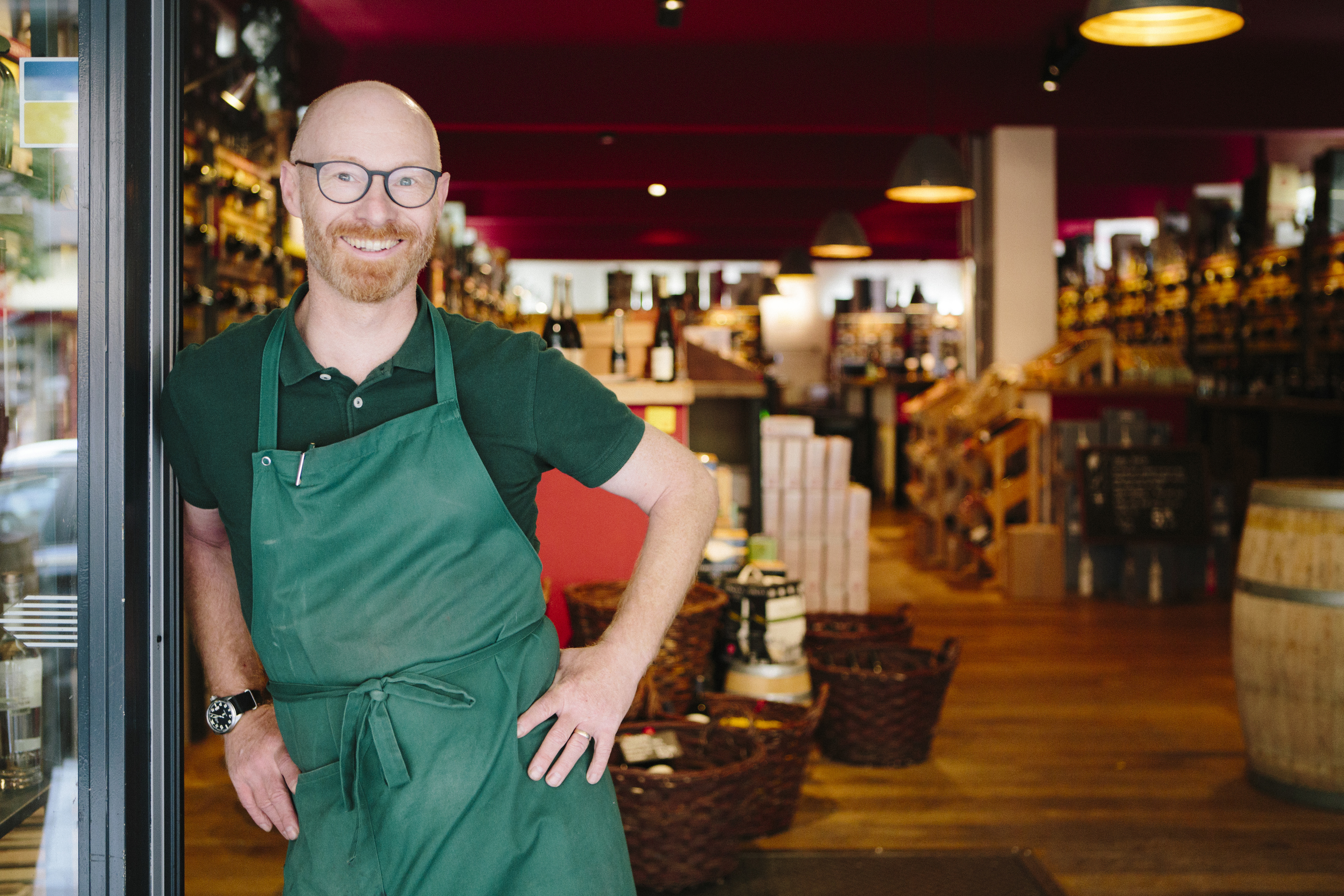 Liquor store owner smiling